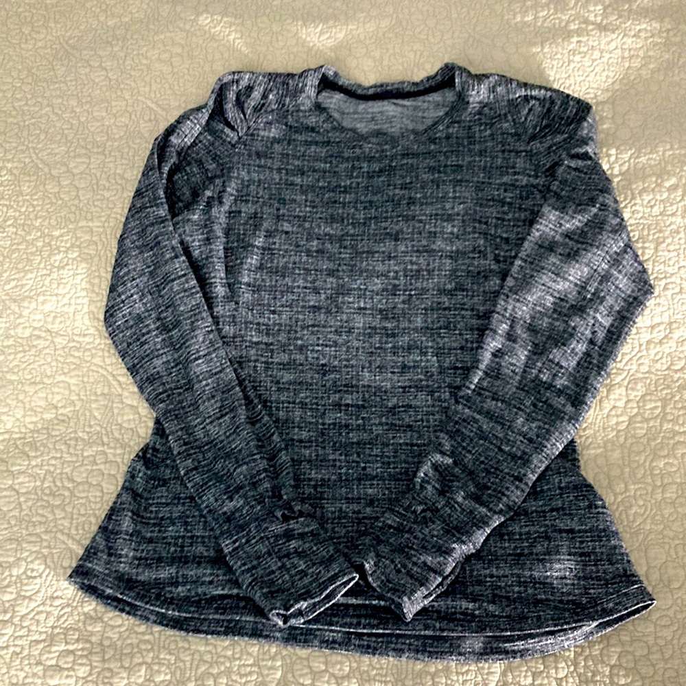 Lululemon running top. Coco pique black. Zipper pocket, ruffle detail. Size 8
